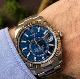 Rolex The Oyster Perpetual Sky-Dweller in White Rolesor with a bright blue dial and an Oyster bracelet. RLX Sky-Dweller RLX-DWELLER